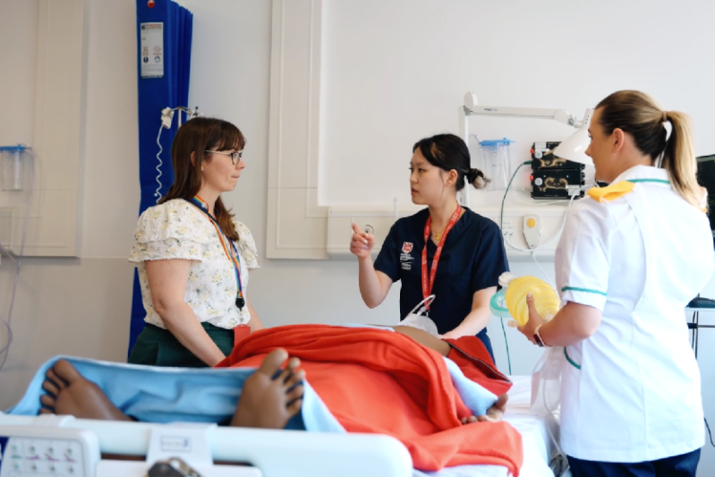 A group of Queen's medical students work with a simulated patient